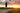 A person jogging down a dirt country path during a golden sunset to reach 10,000 daily steps for cardiovascular disease protection.