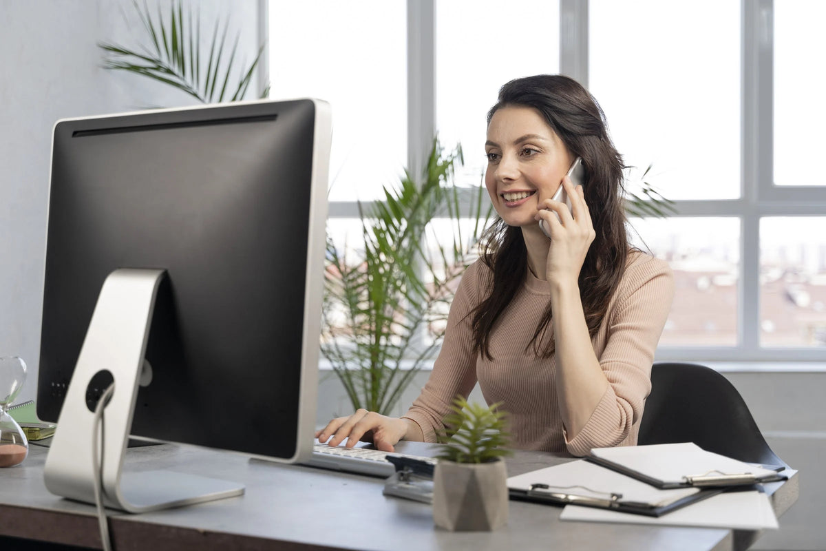 Professional customer support representative at a desk working on a computer and taking a call for Juvina Bioscience.